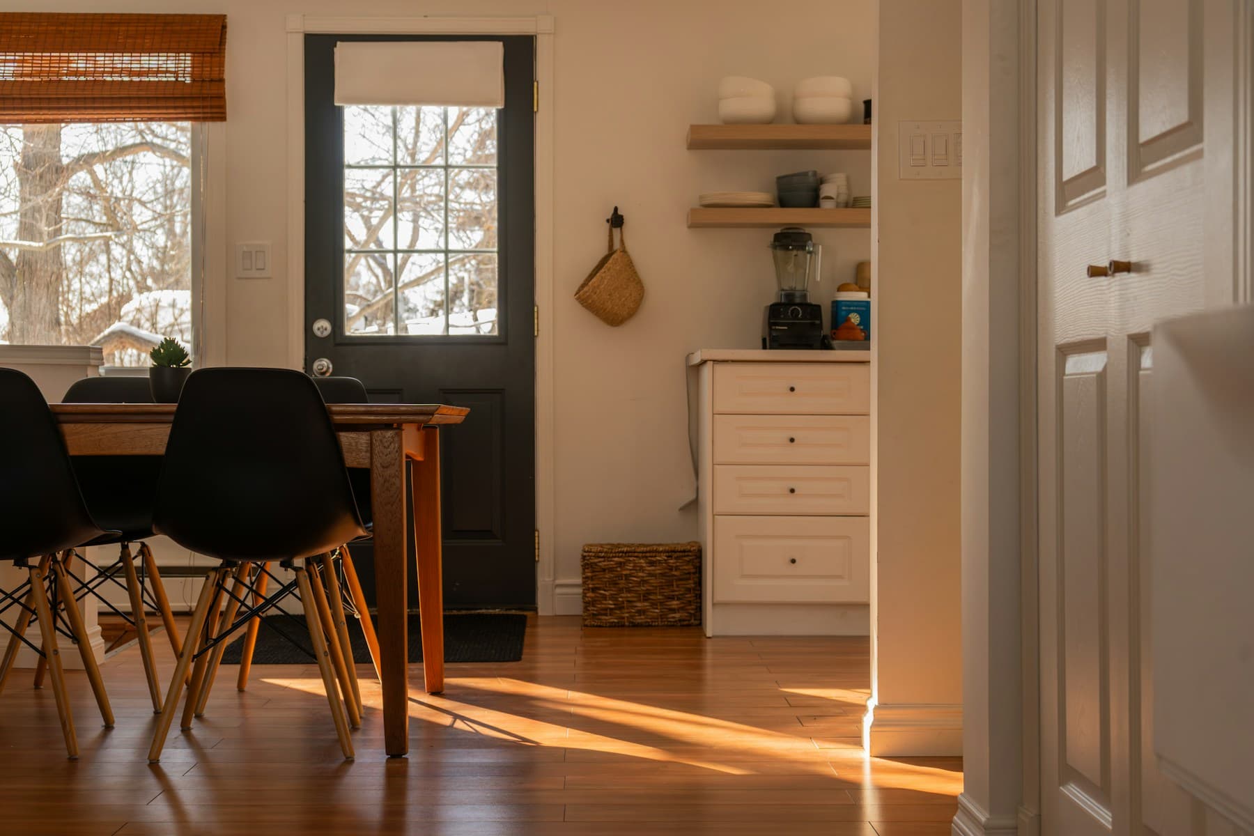 Sunlit dining area alongside a kitchen